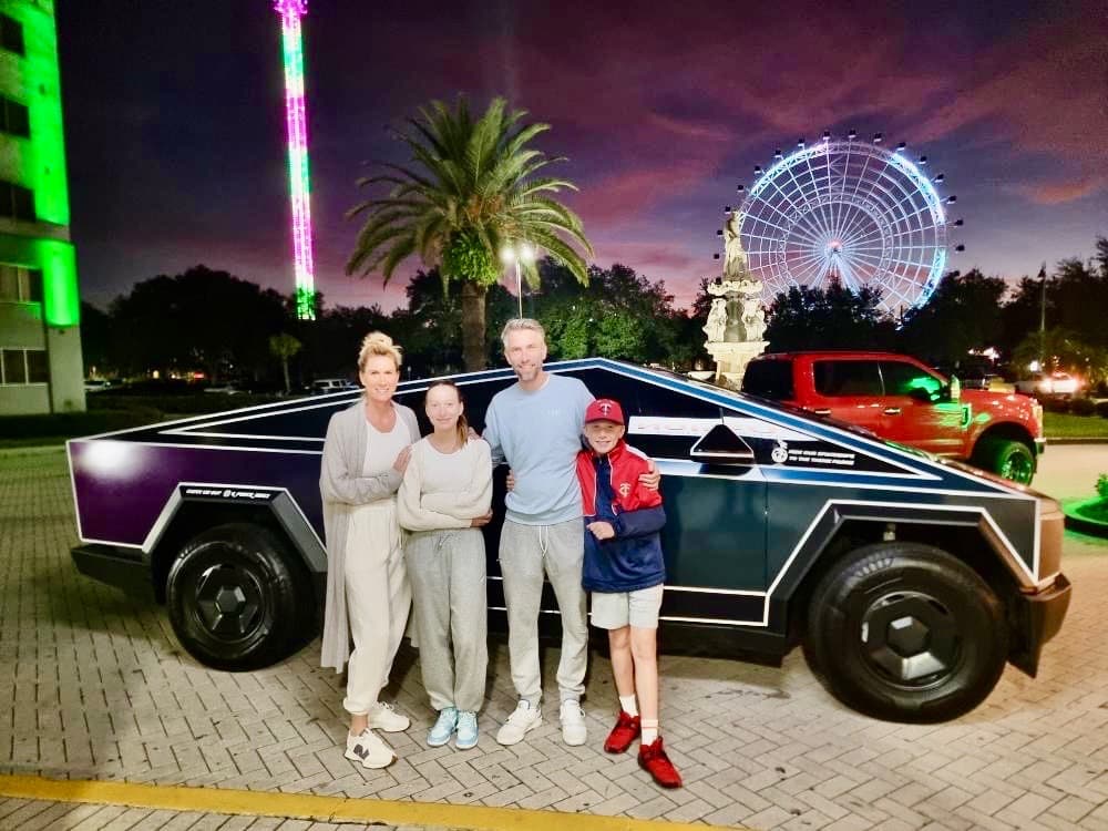 Family posing with the Cybertruck on International Drive